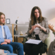 Four people sitting in a group session communicating with each other.