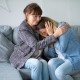 An elderly woman hugging and comforting a younger woman crying.